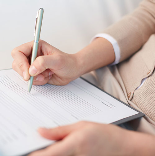 Woman creating a marketing lease-up strategy on paper